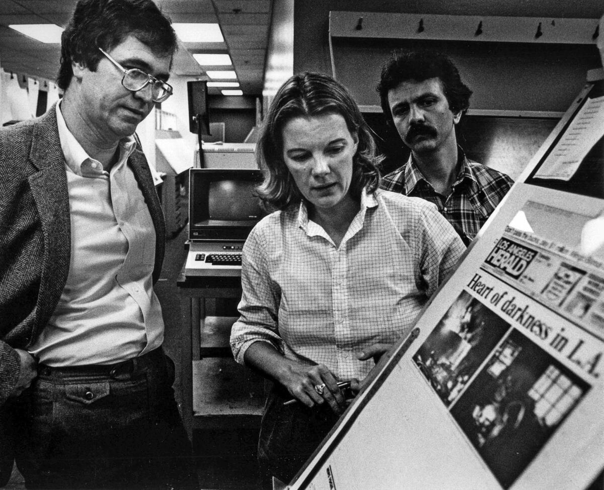 Oct. 11, 1983: Los Angeles Times publisher Tom Johnson and Los Angeles Herald Examiner editor Mary Anne Dolan check out the front page of the Herald Examiner being printed at the Los Angeles Times after to a major power outage.