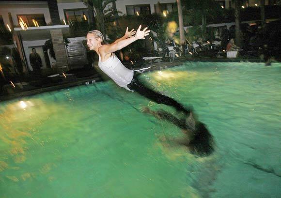 Claudia Roy of Montreal gets flipped through the air at the Hollywood Roosevelt Hotel pool, which is the site of the Night Swim party scene every Tuesday. For several years now, a greater number of upscale hotels in Southern California have been hosting such pool parties, and not just during summer.