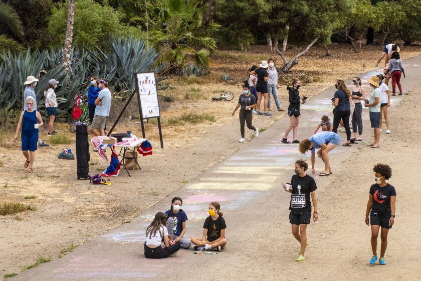 People set up on the La Jolla Bike Path on Labor Day to make chalk art in support of the Black Lives Matter movement.