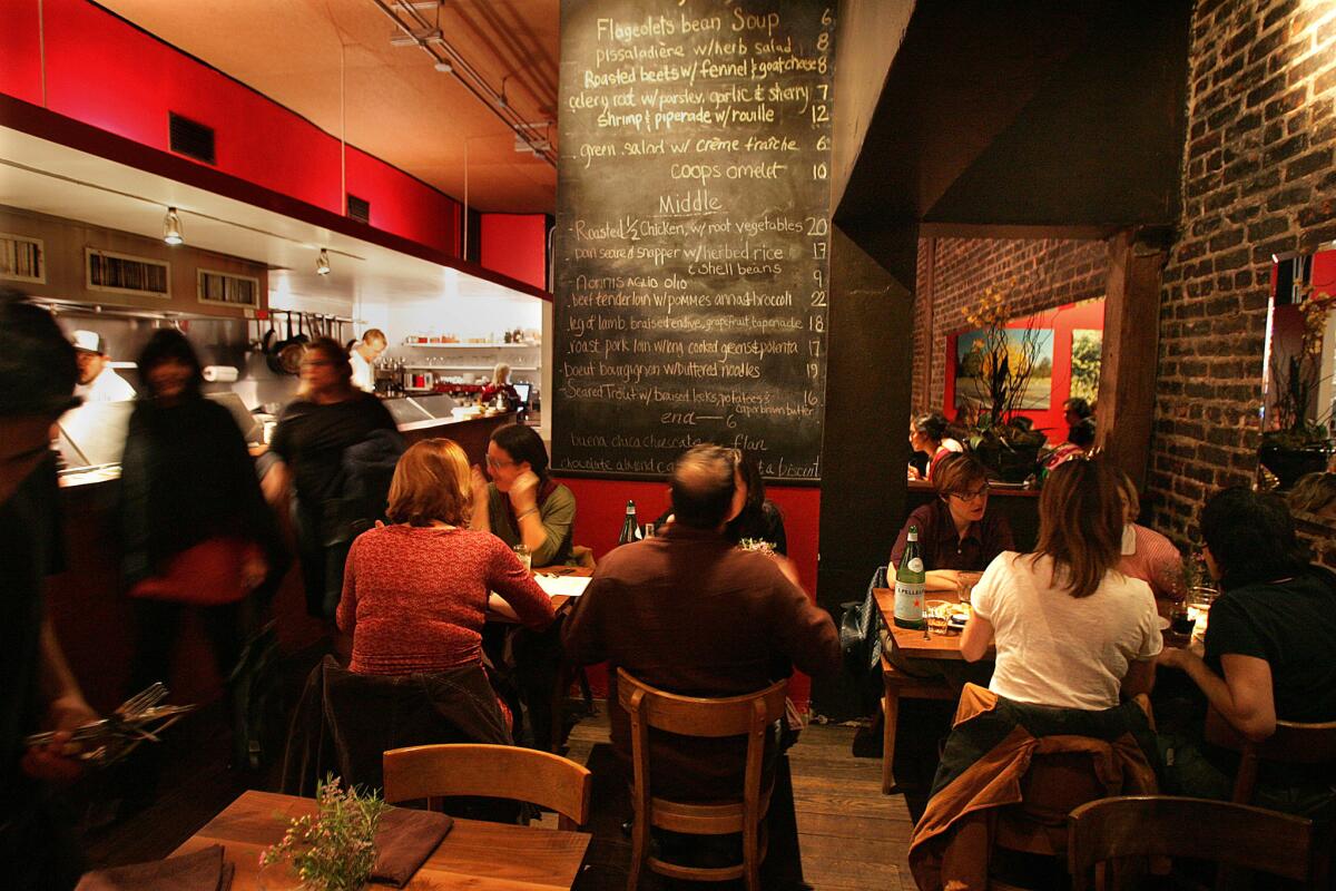 The dining room and kitchen at Canelé in Atwater Village. Chef Corina Weibel is selling her restaurant after a decade of serving the neighborhood.