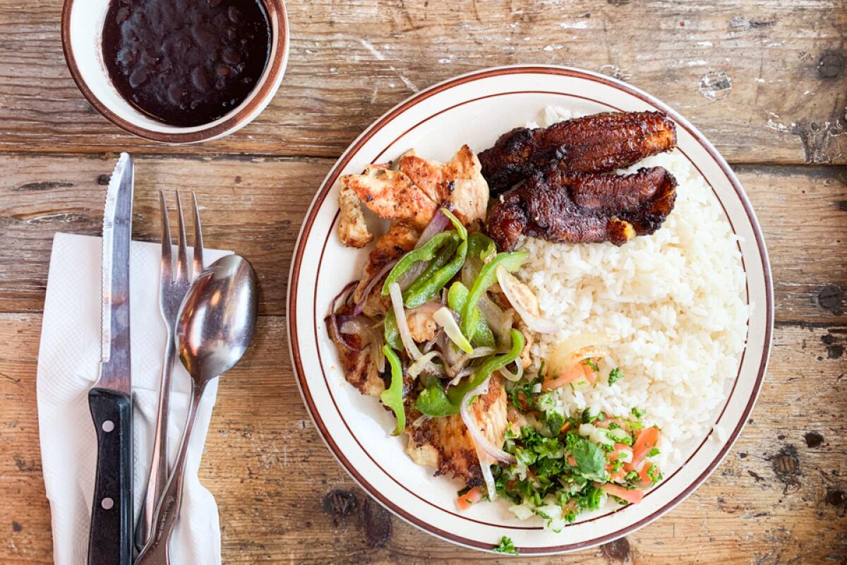 A plate of chicken, rice and plantains with black beans at Cafe Brazil in Culver City.