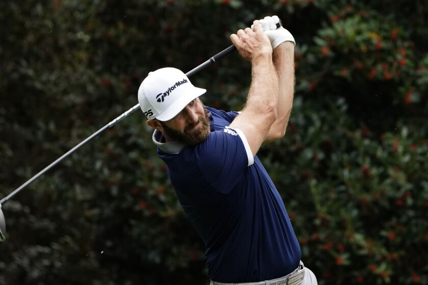 Dustin Johnson hits a shot Nov. 13, 2020, at the Masters. He was a co-leader after the day's play finished.