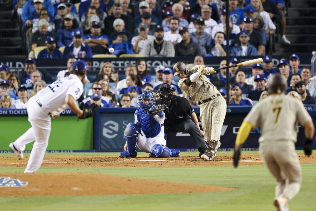 San Diego's Manny Machado hits a run-scoring double off Dodgers pitcher Clayton Kershaw in the third inning.