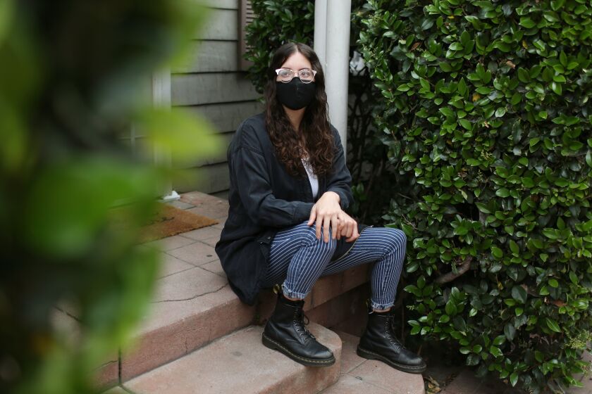 LOS ANGELES, CA - APRIL 12: Shelby Bernstein, 29, feels anxiety seeing people gather at parks without masks or dining at outdoor restaurants and here poses for a portrait outside her home in Westlake on Monday, April 12, 2021 in Los Angeles, CA. (Dania Maxwell / Los Angeles Times)