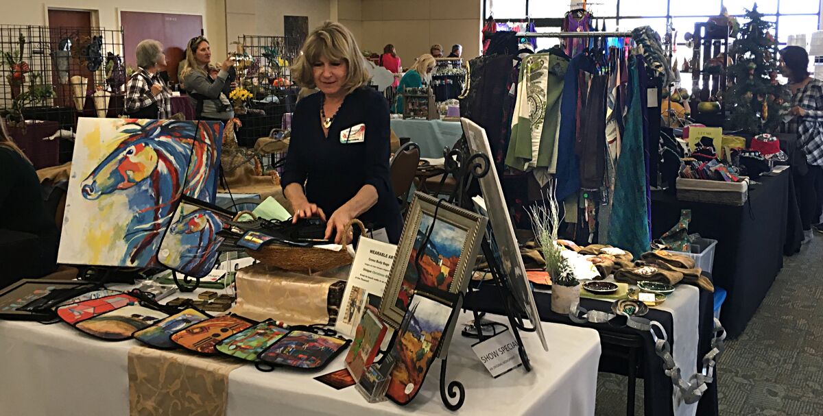 Rosemary Valente with her paintings and cross body bags will be at the Holiday Bazaar.