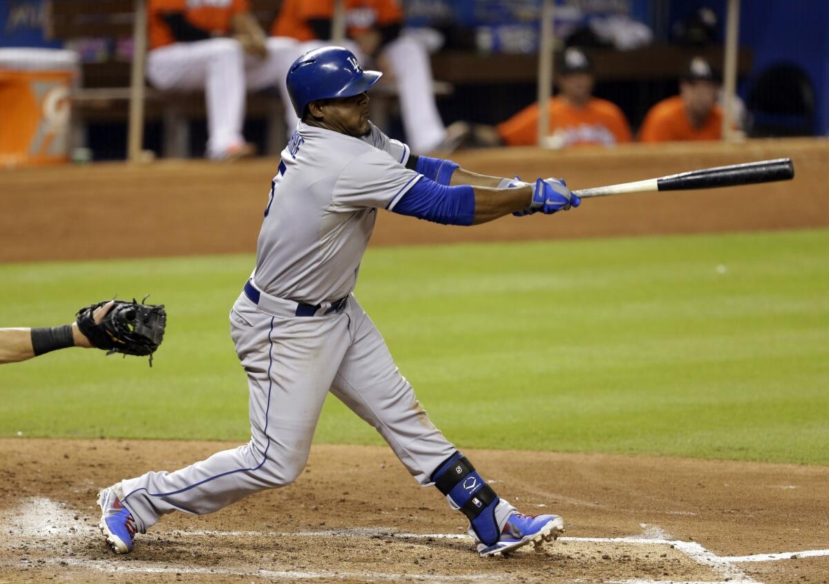 Dodgers third baseman Juan Uribe follows through on a single during the fifth inning of Monday's 6-2 loss to the Miami Marlins.