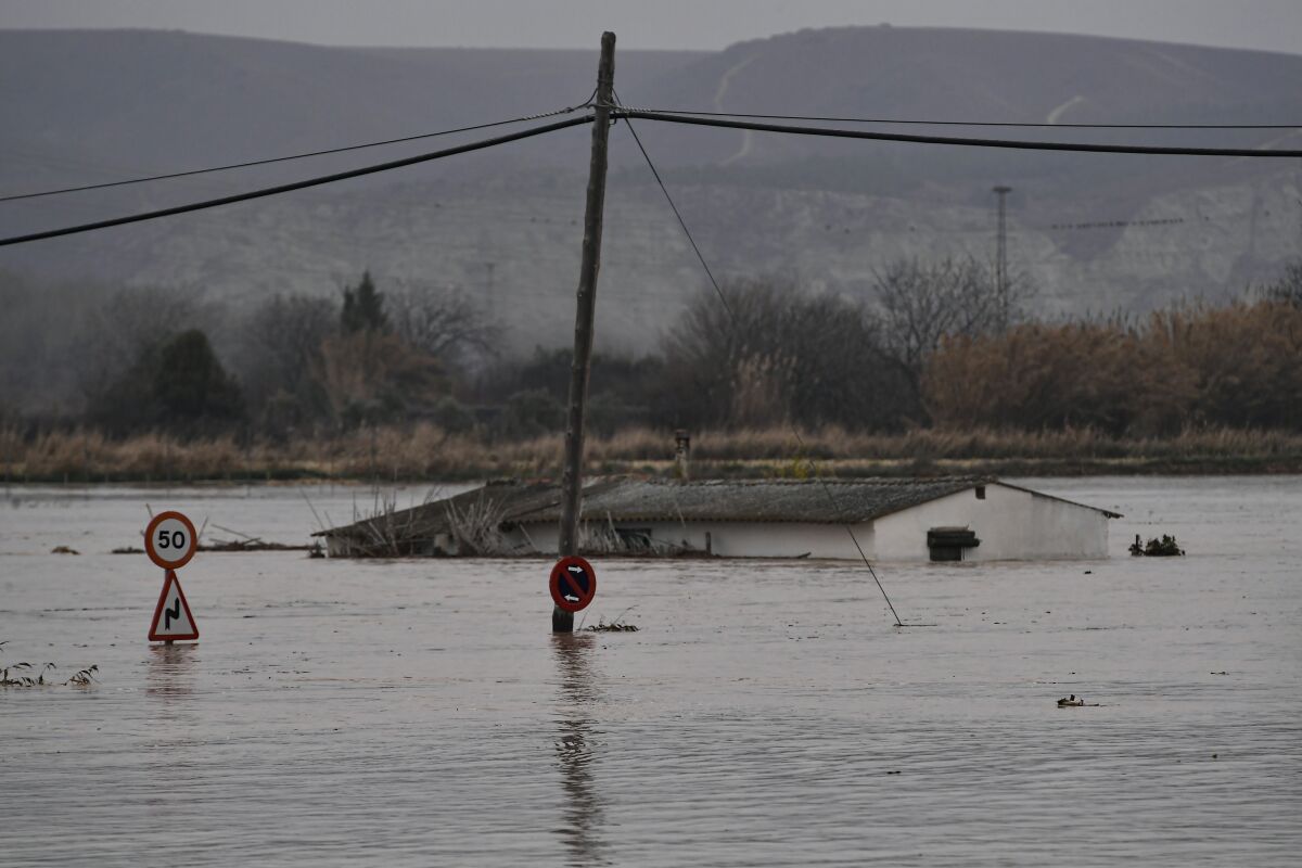 A flooded area near the Ebro River in Alfocena, near to Zaragoza Aragon province, northern Spain, Tuesday, Dec. 14, 2021. Heavy rain has led to flooding in northern Spain. (AP Photo/Alvaro Barrientos)