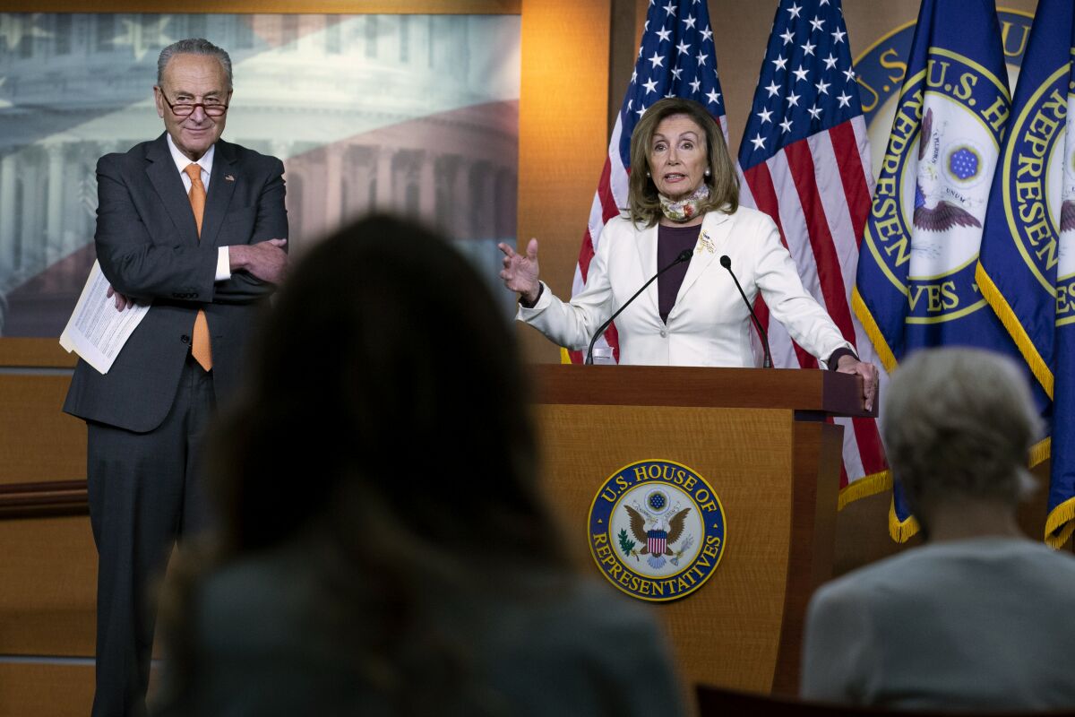 House Speaker Nancy Pelosi, with Senate Minority Leader Charles E. Schumer, speaks Aug. 6 at a Capitol Hill news conference.
