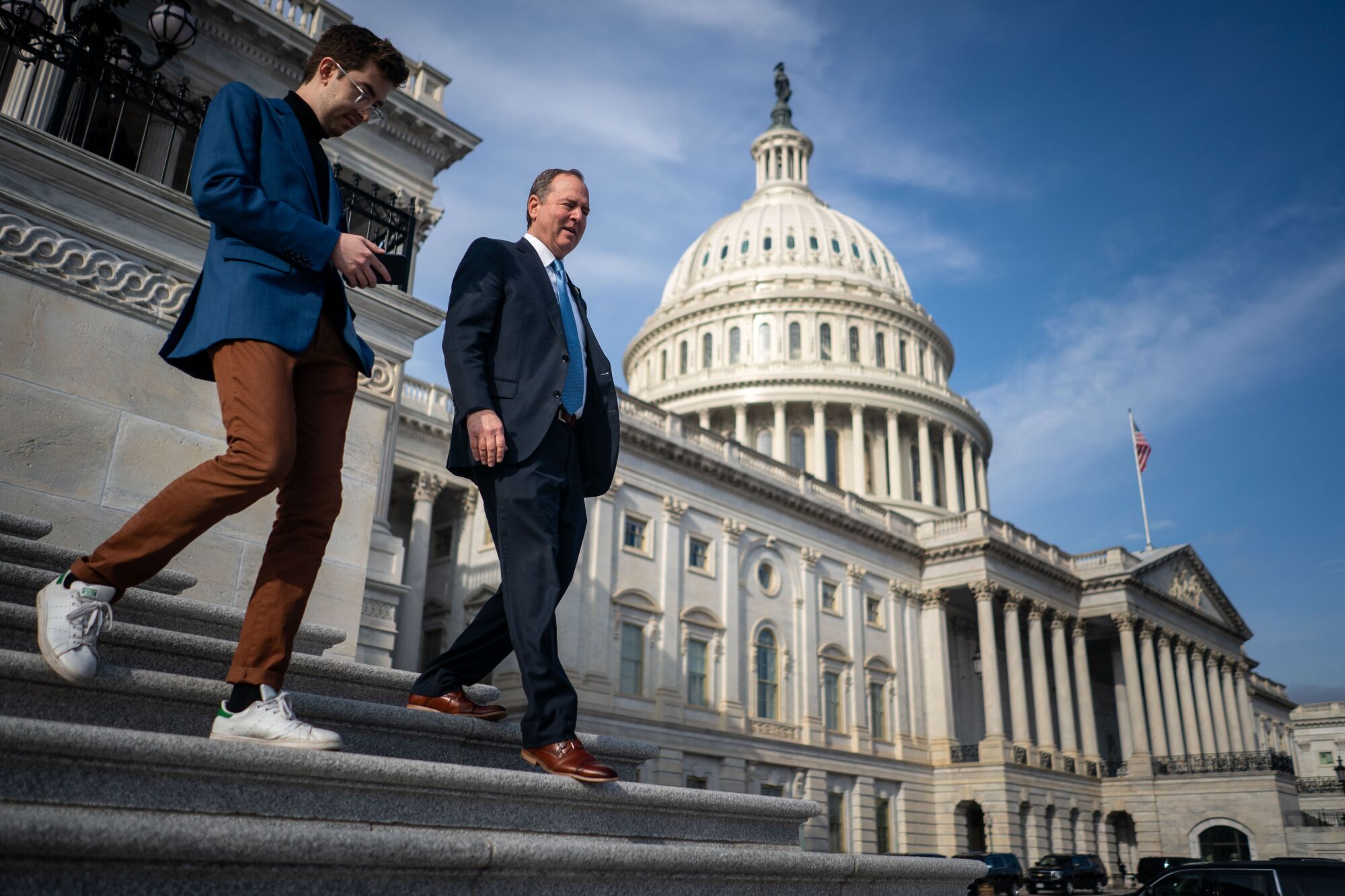 Rep. Adam Schiff speaks with a reporter as he walks down the steps of the US Capitol.