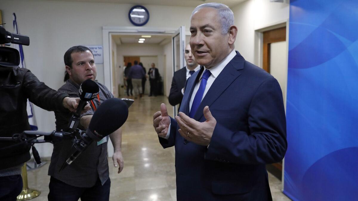 Israeli Prime Minister Benjamin Netanyahu speaks to journalists as he arrives for the weekly cabinet meeting at his office in Jerusalem, Sunday, Feb. 24, 2019. (Abir Sultan/Pool via AP)