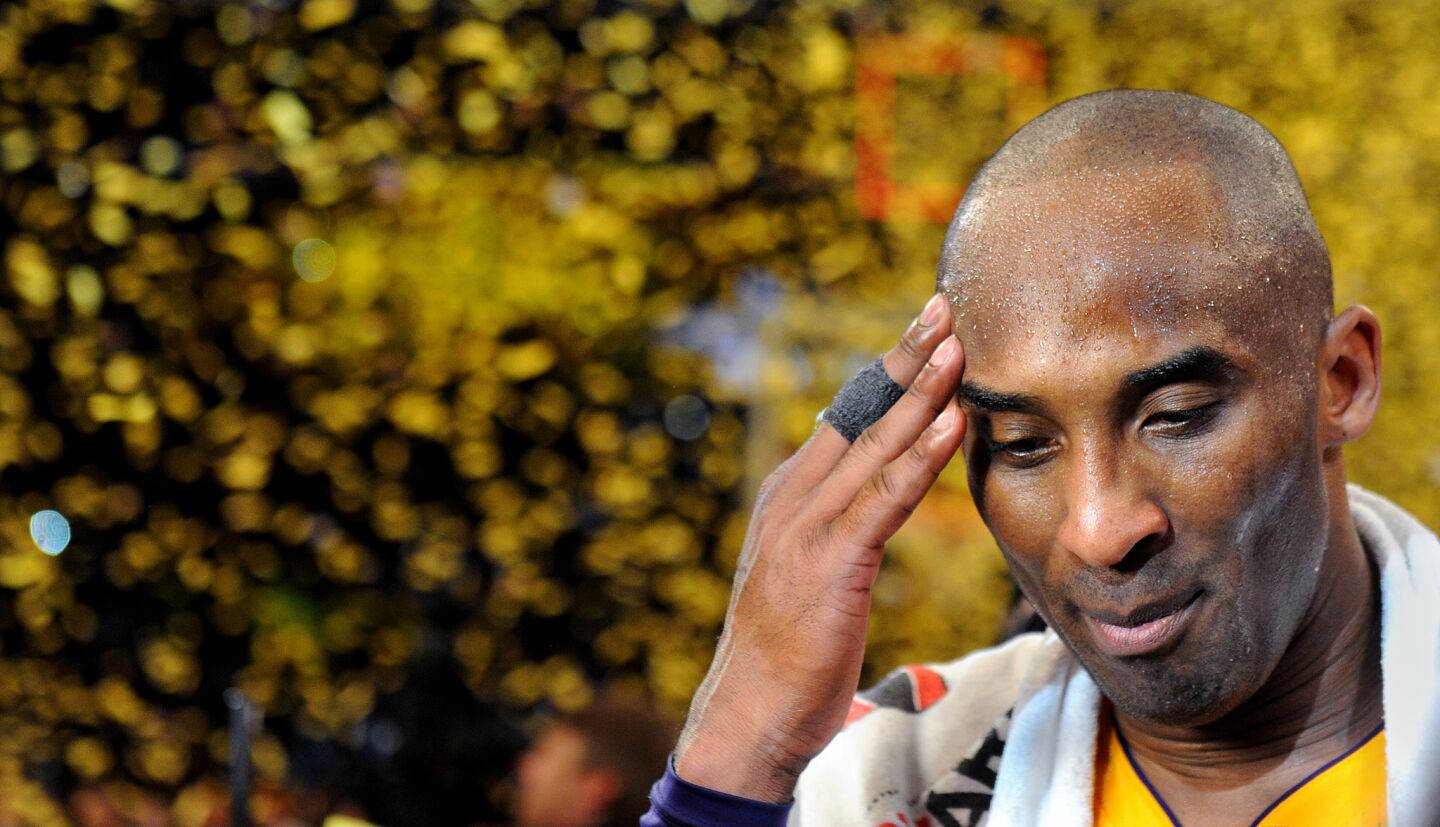 Lakers Kobe Bryant pauses for a moment as confetti streams down following his last game at the Staples Center.