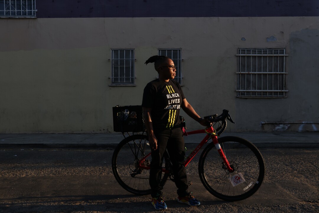 Lena Williams stands with her bike