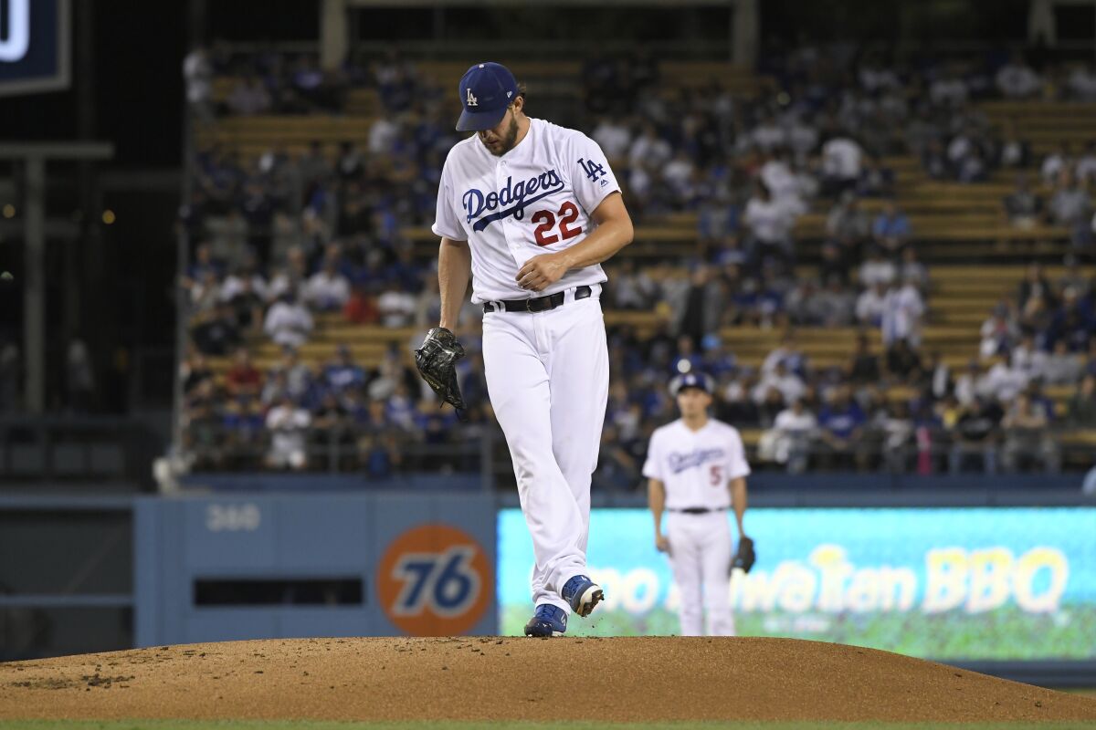 Clayton Kershaw kicks dirt off the mound after giving up consecutive home runs against the Colorado Rockies on Friday night at Dodger Stadium.