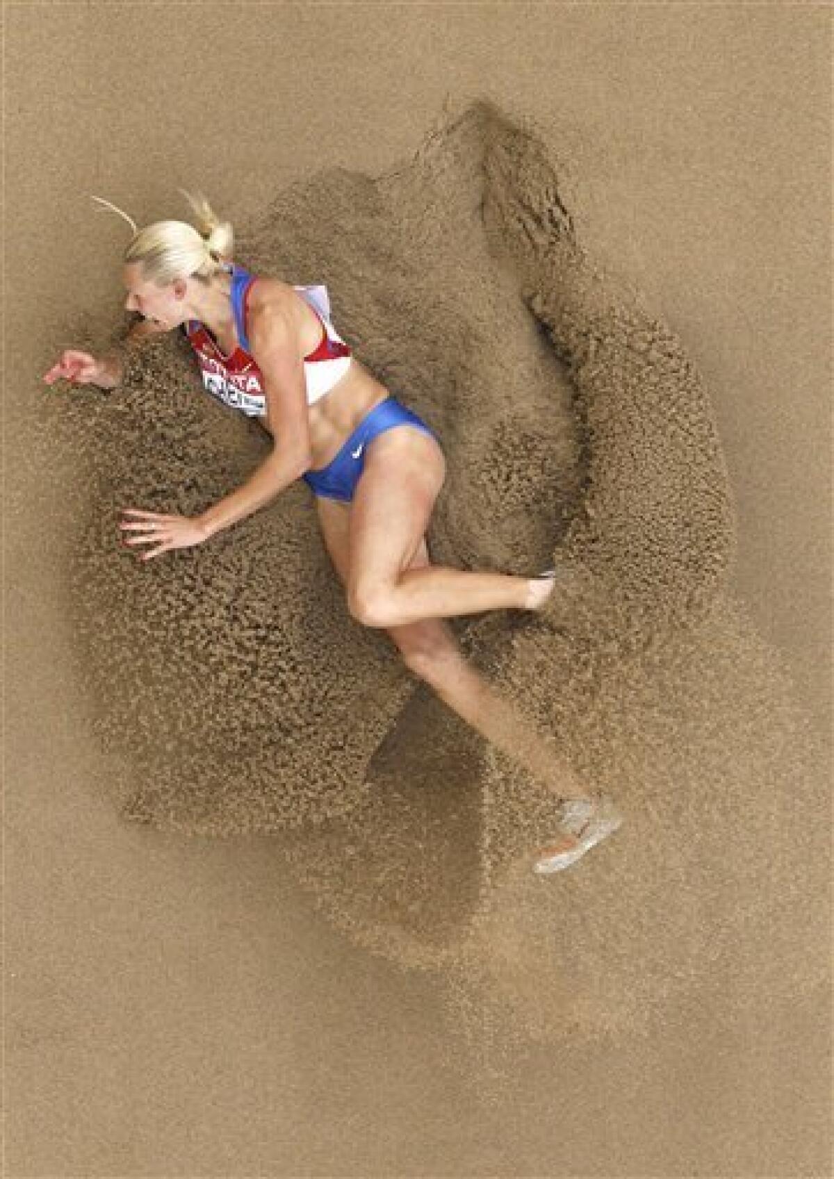 Russia's Tatyana Chernova lands in the sand pit in the Heptathlon Long Jump at the World Athletics Championships in Daegu, South Korea, Tuesday, Aug. 30, 2011. (AP Photo/Kevin Frayer)