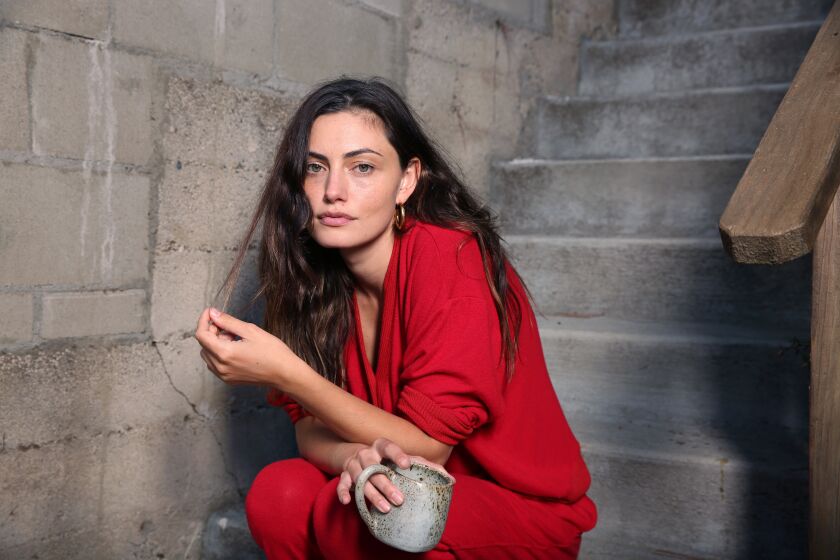 LOS ANGELES , CA - OCTOBER 22: Phoebe Tonkin poses for a portrait wearing her Los Angeles-made sustainable loungewear line called LESJOUR! which will launch this month in her home on Thursday, Oct. 22, 2020 in Los Angeles , CA. She is wearing red, coined "fancy" in the line. (Dania Maxwell / Los Angeles Times)
