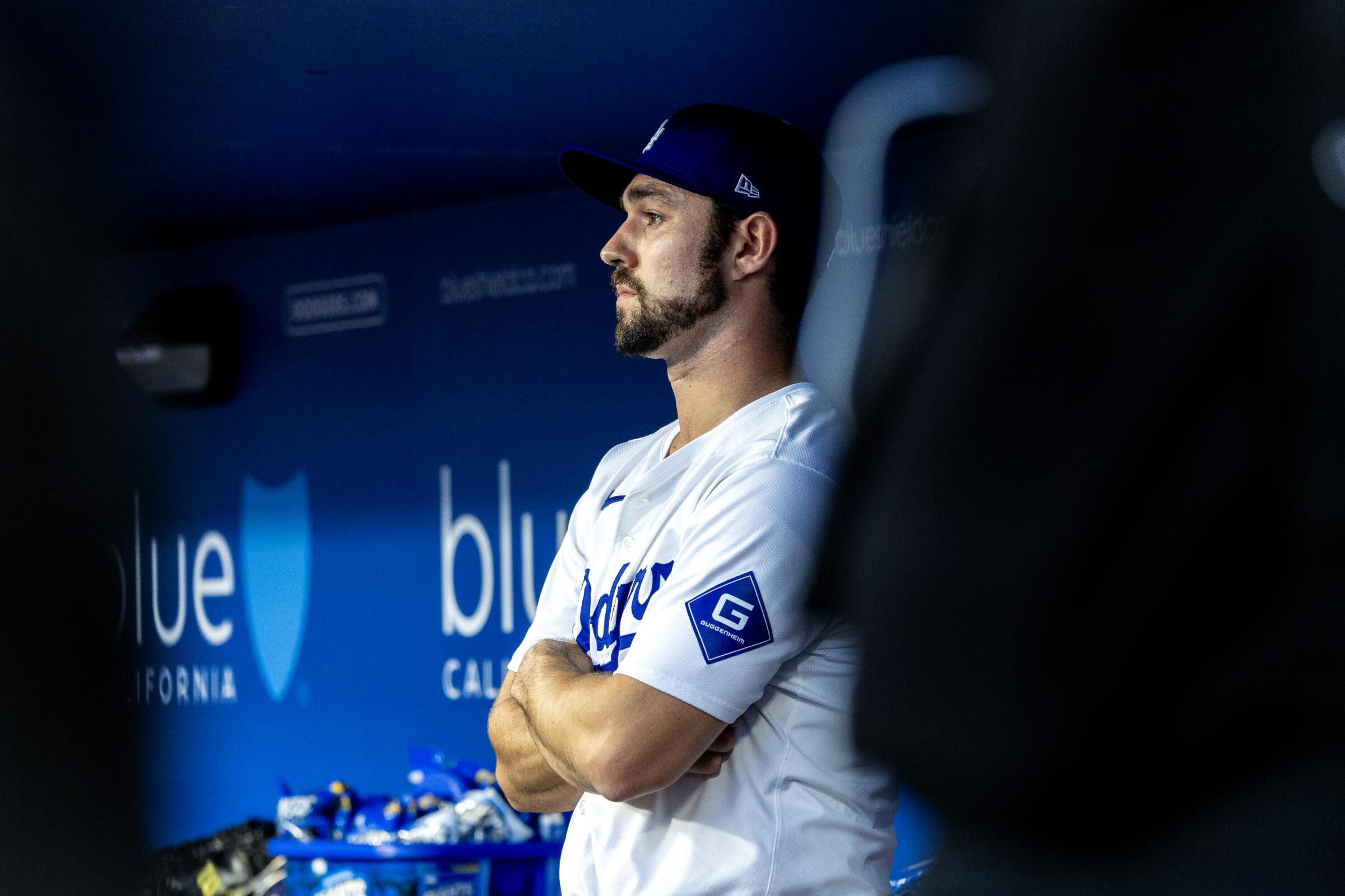 Dodgers reliever J.P. Feyereisen stares out of the dugout after giving up a three-run double to San Diego's Jurickson Profar.