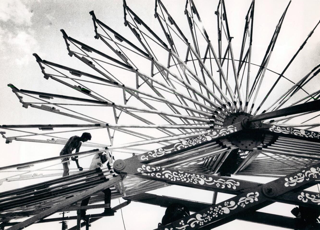 Workers assemble a ride before the 1981 Maryland State Fair.