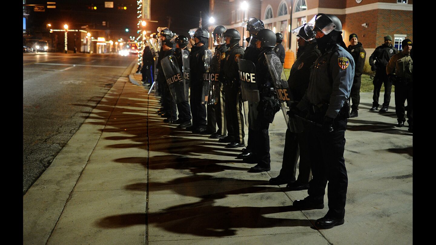 Police officers stand guard outside the Ferguson police station during a demonstration in Missouri Nov. 20. About 30 demonstrators blocked streets while protesting the death of Michael Brown.