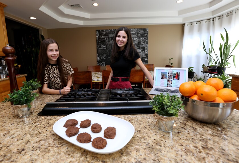 Ashley Sinovoi, 11, left, and her sister Taylor Sinovoi, 15, began a food blog a year and a half ago at their home in Burbank. The food blog is called wereviewyouchew.com.