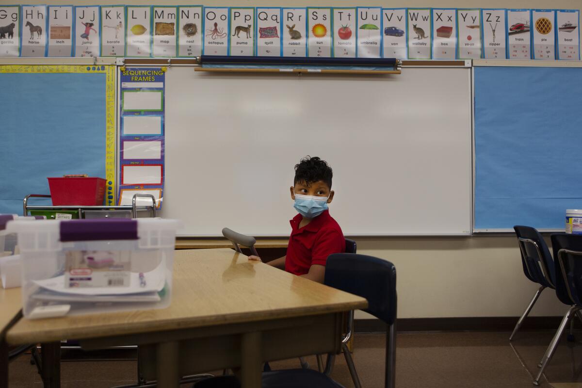 A student sits inside a classroom at Brooklyn Avenue Elementary in East Los Angeles on Aug. 18, 2021.