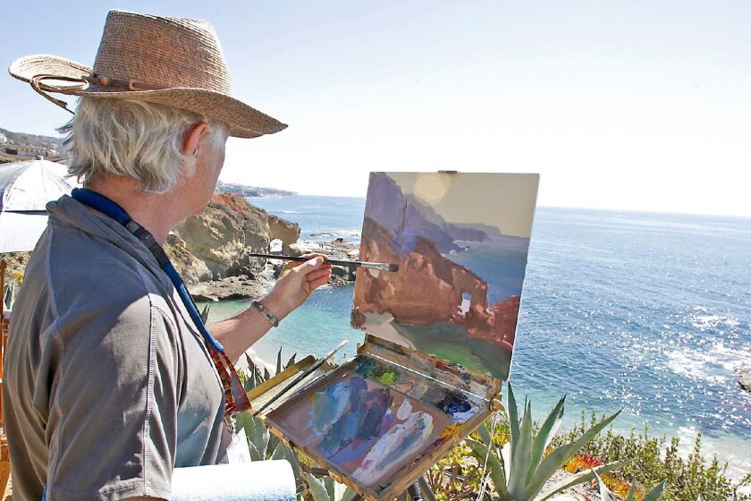 Artist Bill Davidson paints the arch and coves where he participates in Laguna Beach's Plein Air Invitational at the Montage Resort on Saturday.
