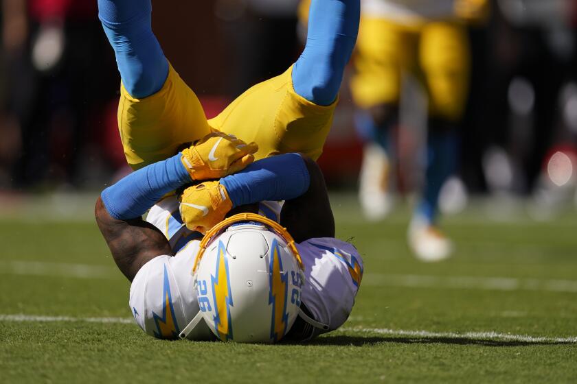 Los Angeles Chargers' Asante Samuel Jr. (26) makes an interception during the first half of an NFL football game against the Kansas City Chiefs, Sunday, Sept. 26, 2021, in Kansas City, Mo. (AP Photo/Charlie Riedel)