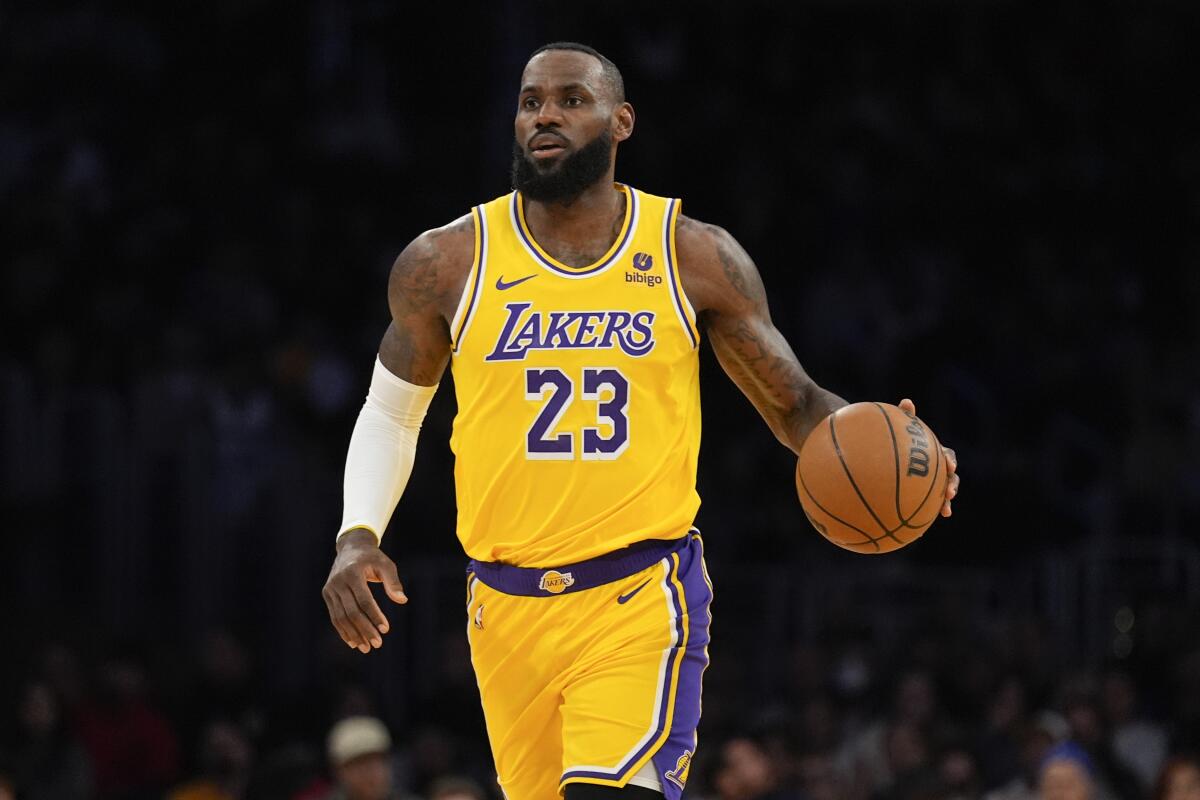 Lakers forward LeBron James dribbles the ball up court during the first half of a game against the Kings on Wednesday.