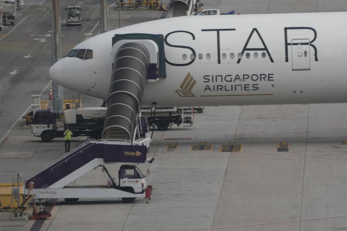 A jetliner that says "Star" and "Singapore Airlines" on the side is parked 