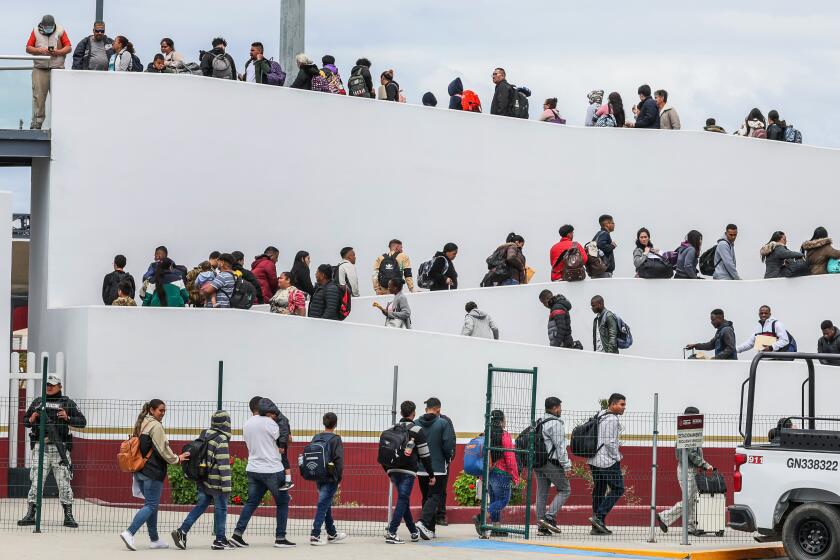 Tijuana, Mexico, Thursday, April 25, 2024 - Hundreds of asylum seekers who used a CBP phone app to make an appointment, are led to their interviews with U.S. customs agents at the San Ysidro Border Crossing. (Robert Gauthier/Los Angeles Times)