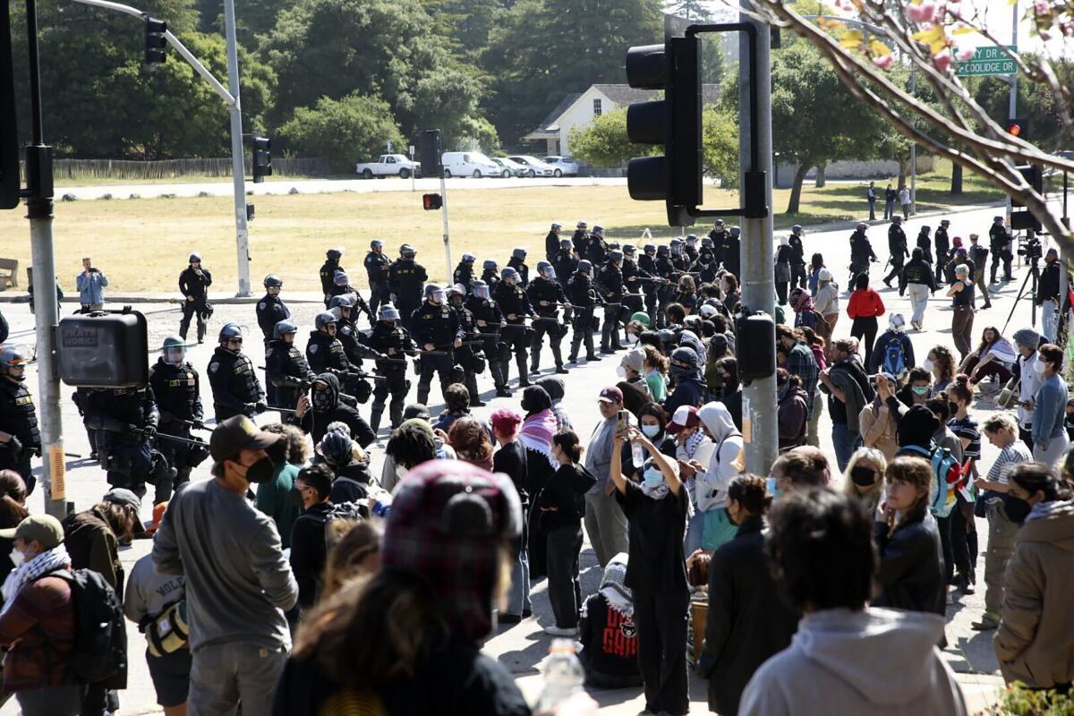 Police in riot gear stand off against pro-Palestinian demonstrators at the University of 