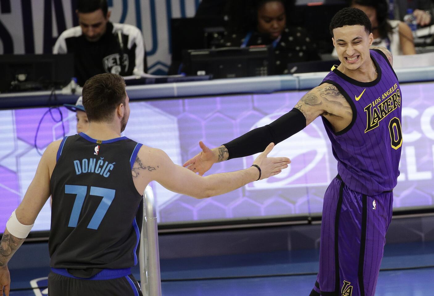 Lakers Kyle Kuzma congratulates Mavericks forward Luka Doncic after losing in the first round of the skills competition.