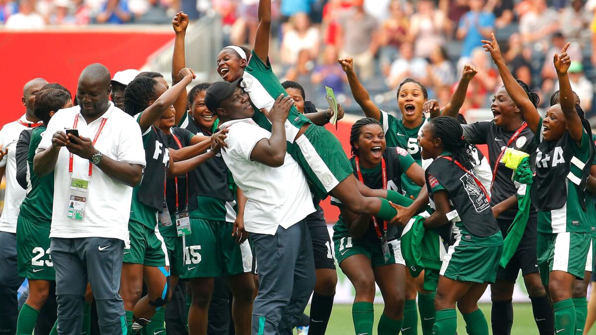 Ngozi Okobi is lifted by a coach and teammates after she was selected player of the match following a 3-3 tie with Sweden in group play of the Women's World Cup on June 8.
