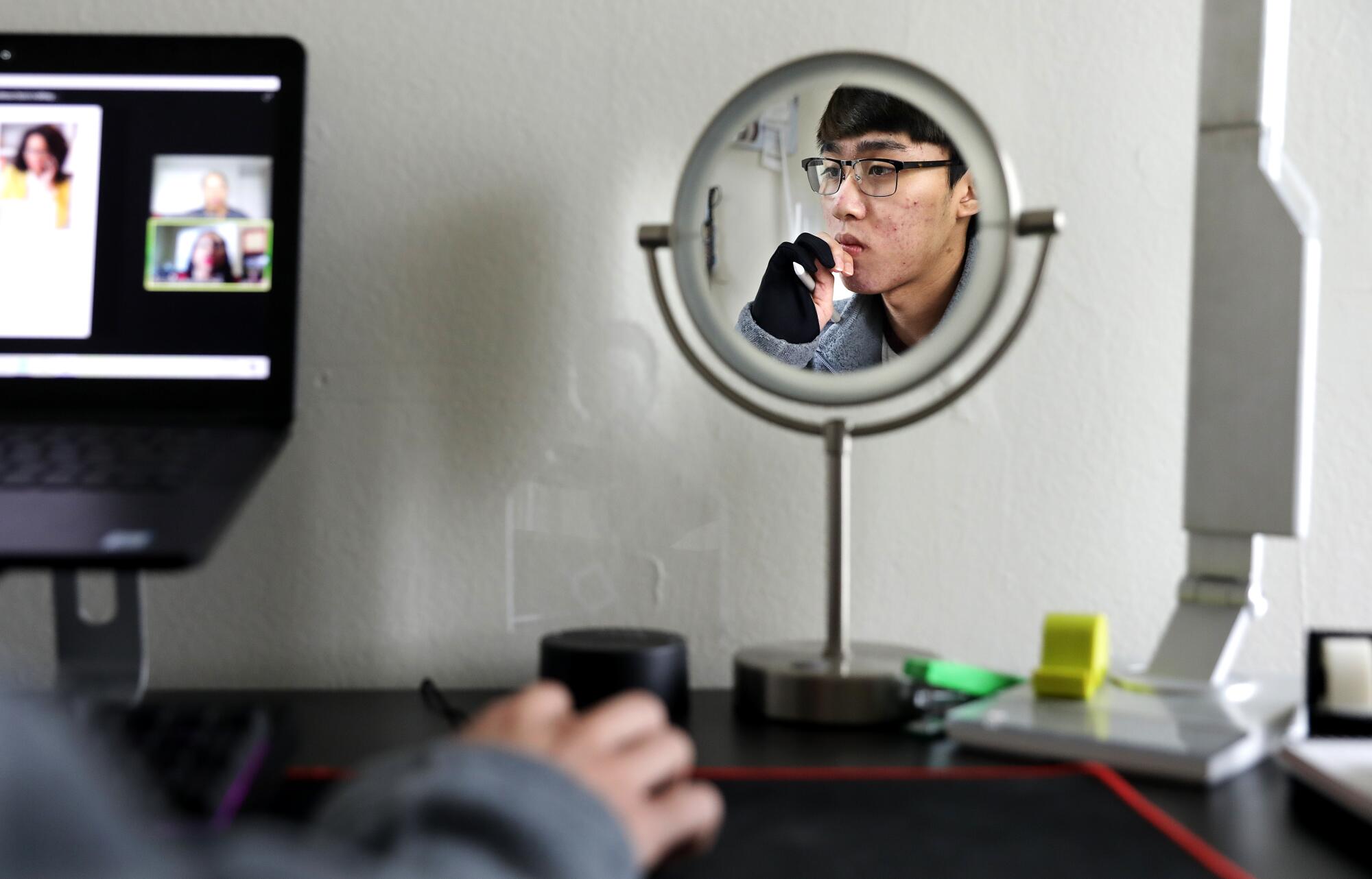 Raven Ferrer attends a Zoom meeting at home in Monterey Park.