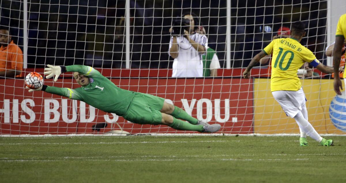 Brazil's Neymar, right, scores on a penalty kick against U.S. goalkeeper Brad Guzan on Sept. 8.