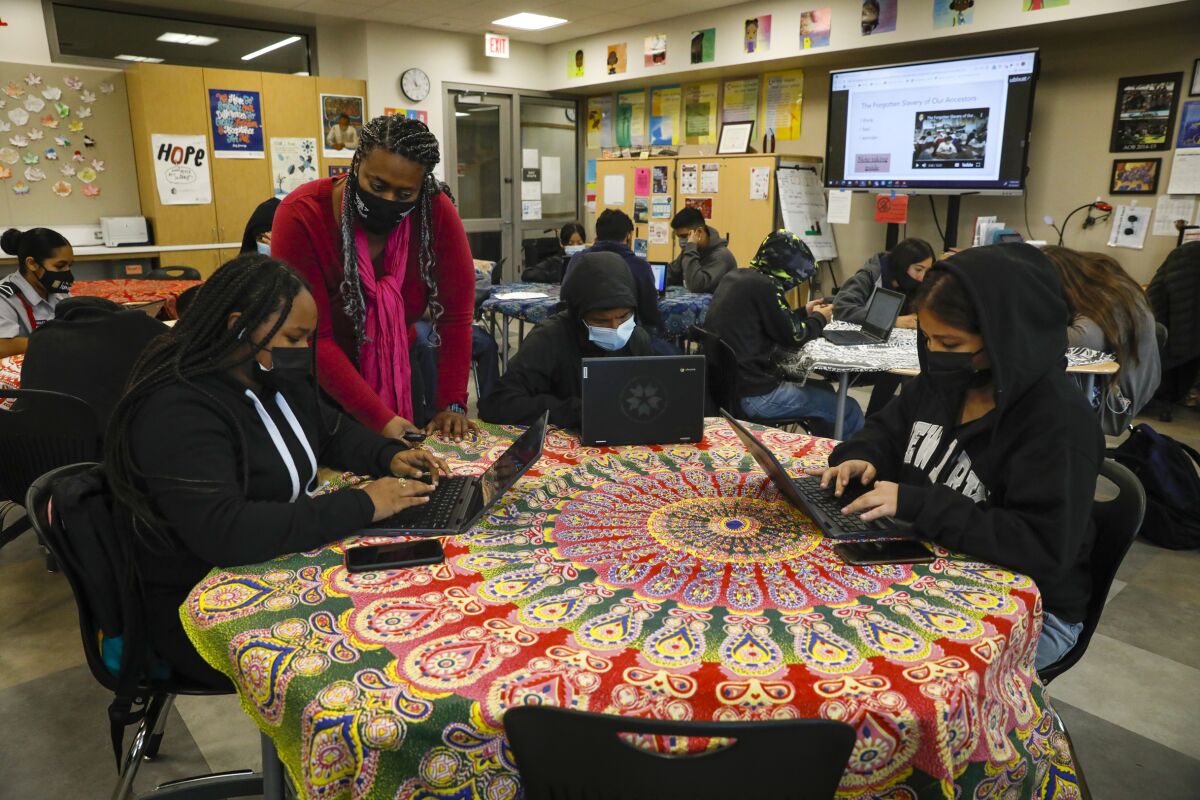 Hoover High School teacher Sharon Apple works with ninth-grade students in an Introduction to Ethnic Studies class