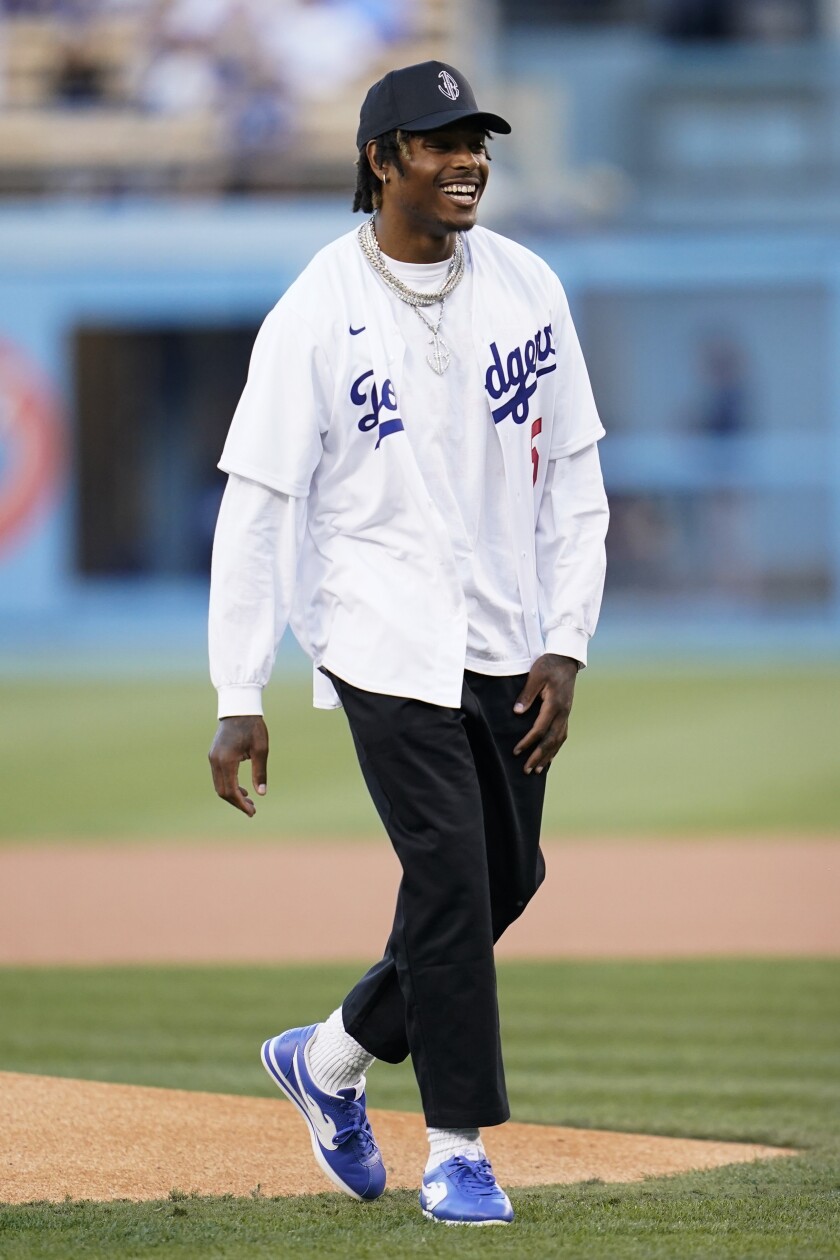 Rams cornerback Jalen Ramsey smiles after throwing out the first pitch at the Dodgers game Oct. 2, 2021.