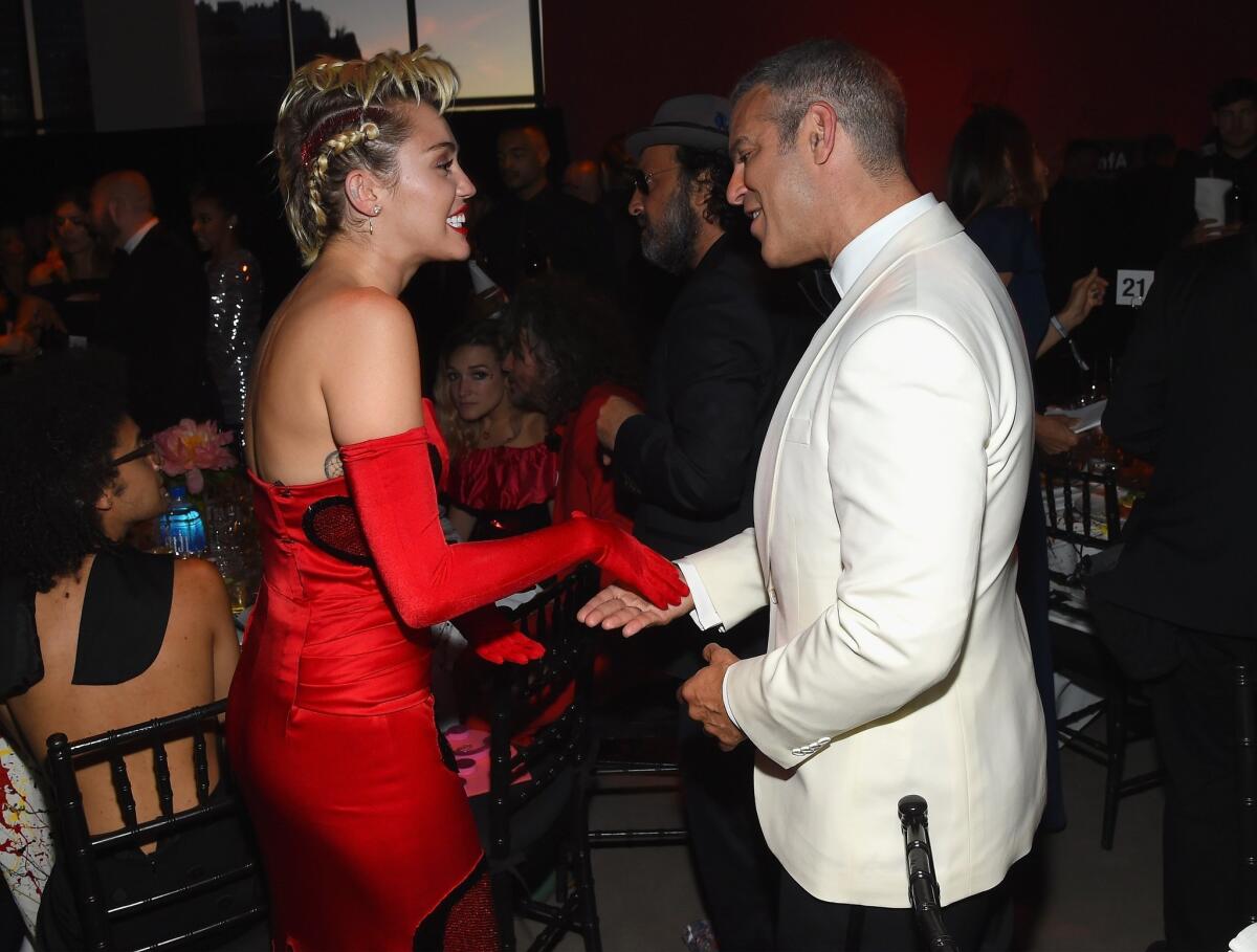 Miley Cyrus and Andy Cohen attend the 2015 amfAR Inspiration Gala New York at Spring Studios in New York City.