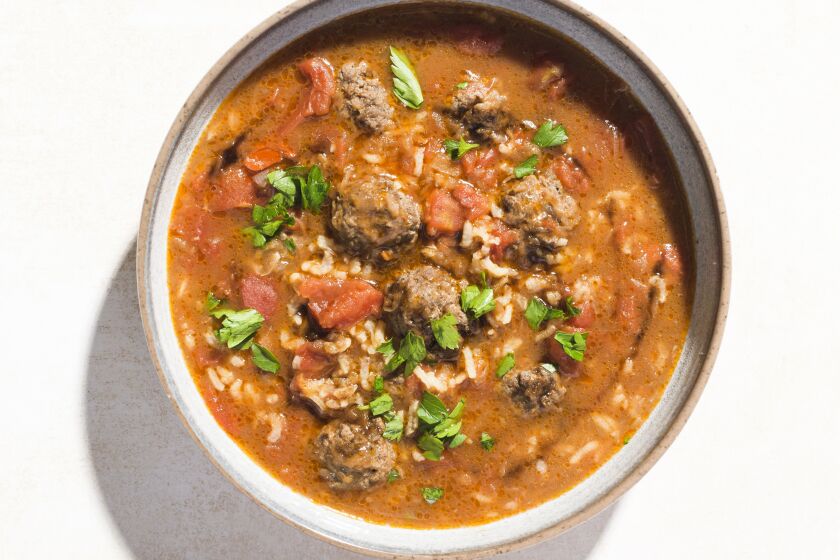 This image released by Milk Street shows a recipe for Syrian-style Meatball Soup w/Rice and Tomatoes. (Milk Street via AP)