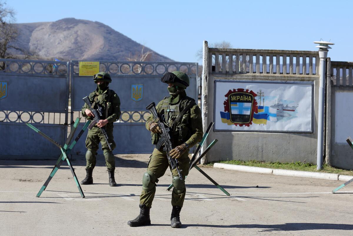 Russian soldiers stand guard in front of a Ukrainian military base in the Crimean peninsula.
