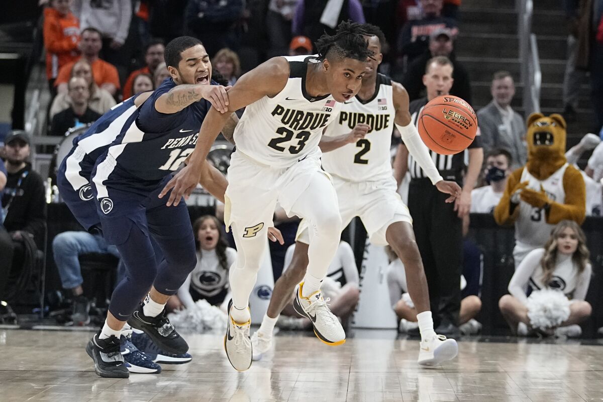 Purdue's Jaden Ivey (23) chases down the ball against Penn State's Sam Sessoms, left, during the second half of an NCAA college basketball game at the Big Ten Conference tournament, Friday, March 11, 2022, in Indianapolis. (AP Photo/Darron Cummings)