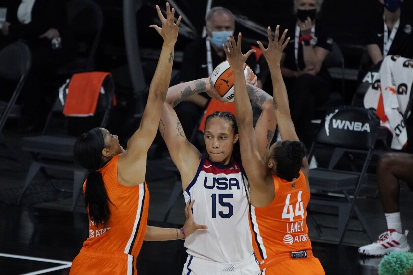 Team WNBA's Candace Parker and Betnijah Laney guard United States' Brittney Griner.
