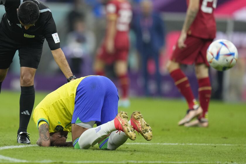 Brazil's Neymar kneels on the pitch during the World Cup group G soccer match between Brazil and Serbia, at the Lusail Stadium in Lusail, Qatar, Thursday, Nov. 24, 2022. (AP Photo/Aijaz Rahi)