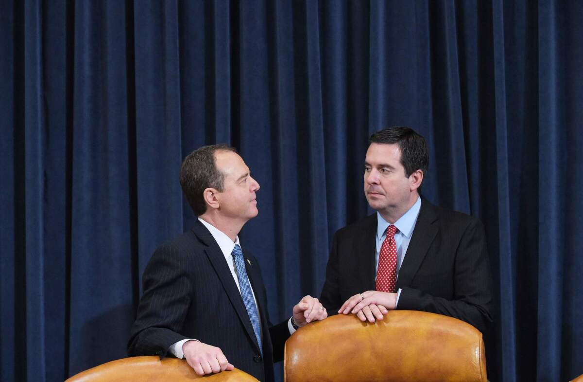 Rep. Adam Schiff, left, and Rep. Devin Nunes chat before taking their seats during a House Intelligence Committee hearing on Russian actions during the 2016 election campaign on March 20, 2017.