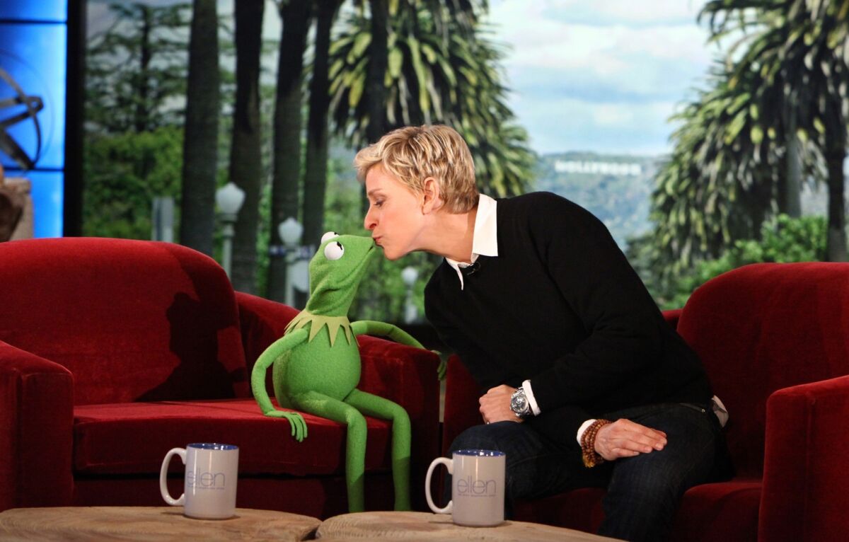 Ellen DeGeneres kisses Kermit the Frog.