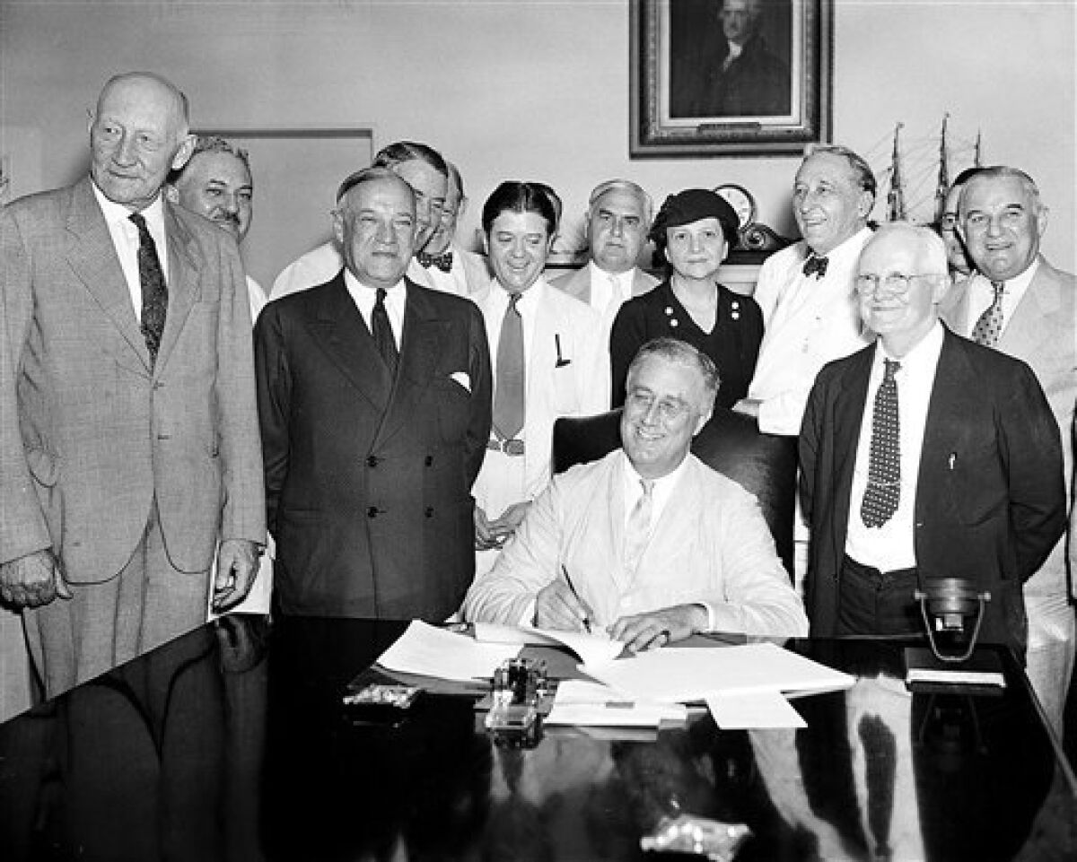  In this Aug. 14, 1935, file photo President Franklin Roosevelt signs the Social Security Bill in Washington, D.C. 