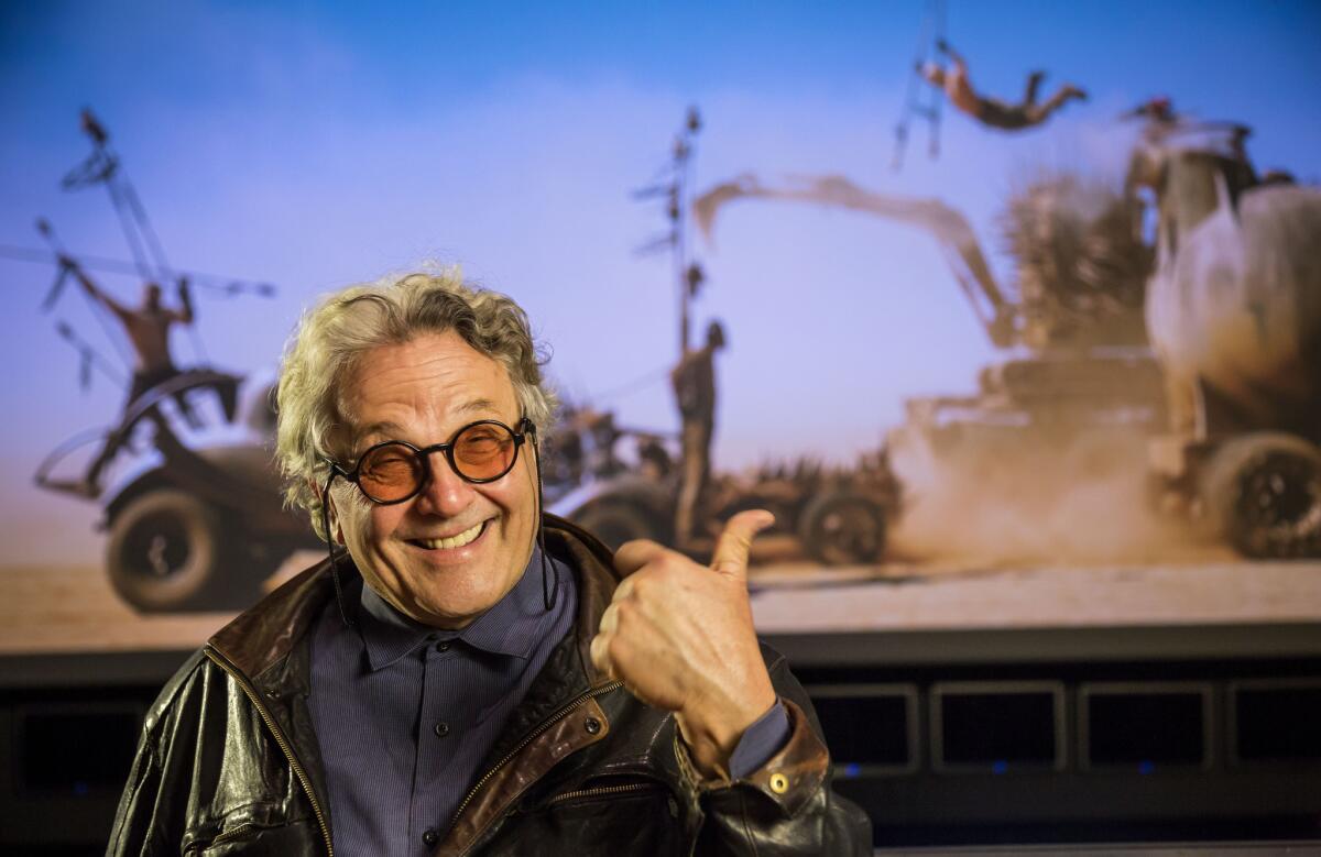 Australian director George Miller photographed in a Post Production stage at Warner Brothers Studios, with a scene from "Mad Max: Fury Road" as a backdrop.