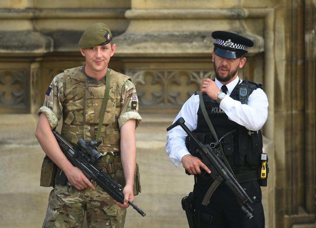 A British Army soldier on guard next to an armed police officer by the Houses of Parliament of in London on May 25, 2017.
