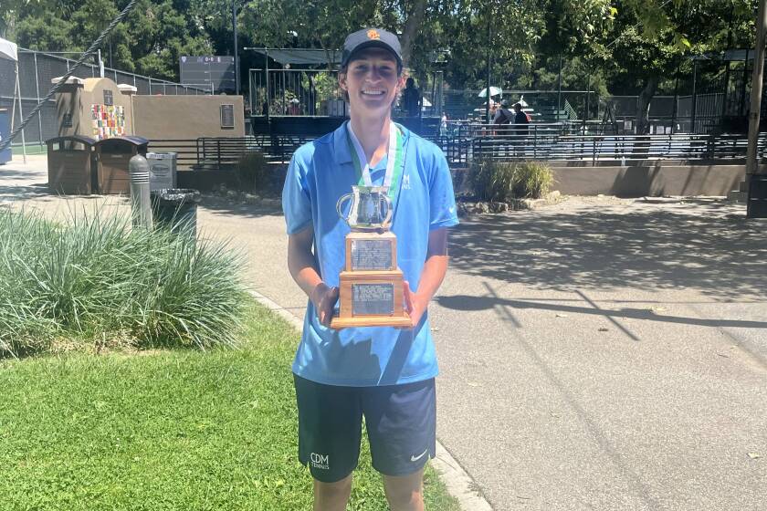 CdM boys' tennis senior Niels Hoffmann with the Farnam Cup perpetual trophy after winning the Ojai Tournament title on Saturday.