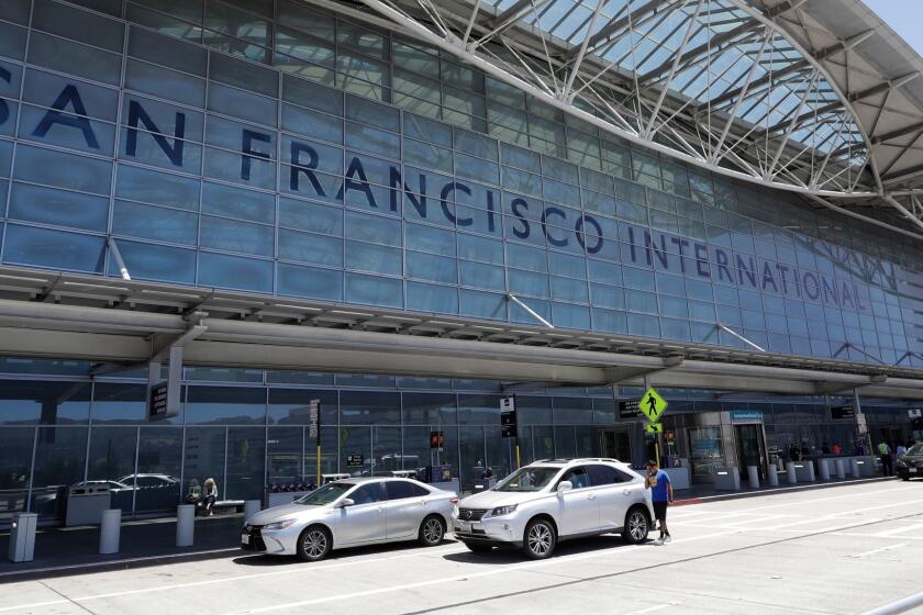 Vehicles wait outside the international terminal at San Francisco International Airport Tuesday, July 11, 2017, in San Francisco. Federal safety officials are investigating why an Air Canada jet nearly landed on a taxiway last Friday, holding four other planes instead of a runway at at the airport. (AP Photo/Marcio Jose Sanchez)