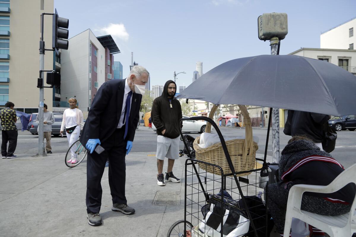Judge David O. Carter asks a skid row resident how long the water dispensers have been dry